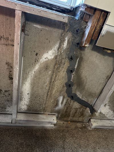 Unfinished wall with mold forming on it