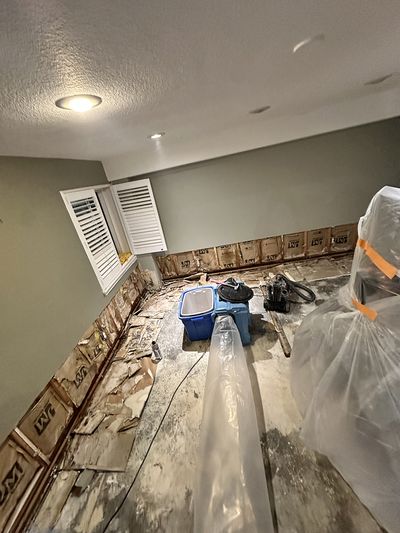 Flooring and walls stripped apart in a previously flooded basement
