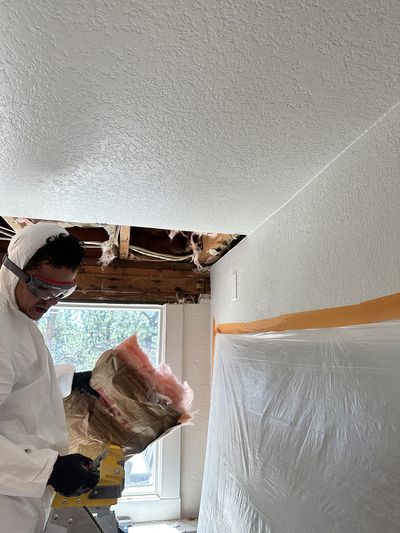 declare it restored and remodeled technician removing parts from a water-damaged ceiling