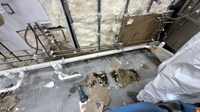 Commercial building walls stripped apart to show evidence of water damage and mold