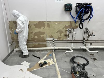 Technician from declare it restored & remodeled in a hazmat suit locating mold in a commercial building